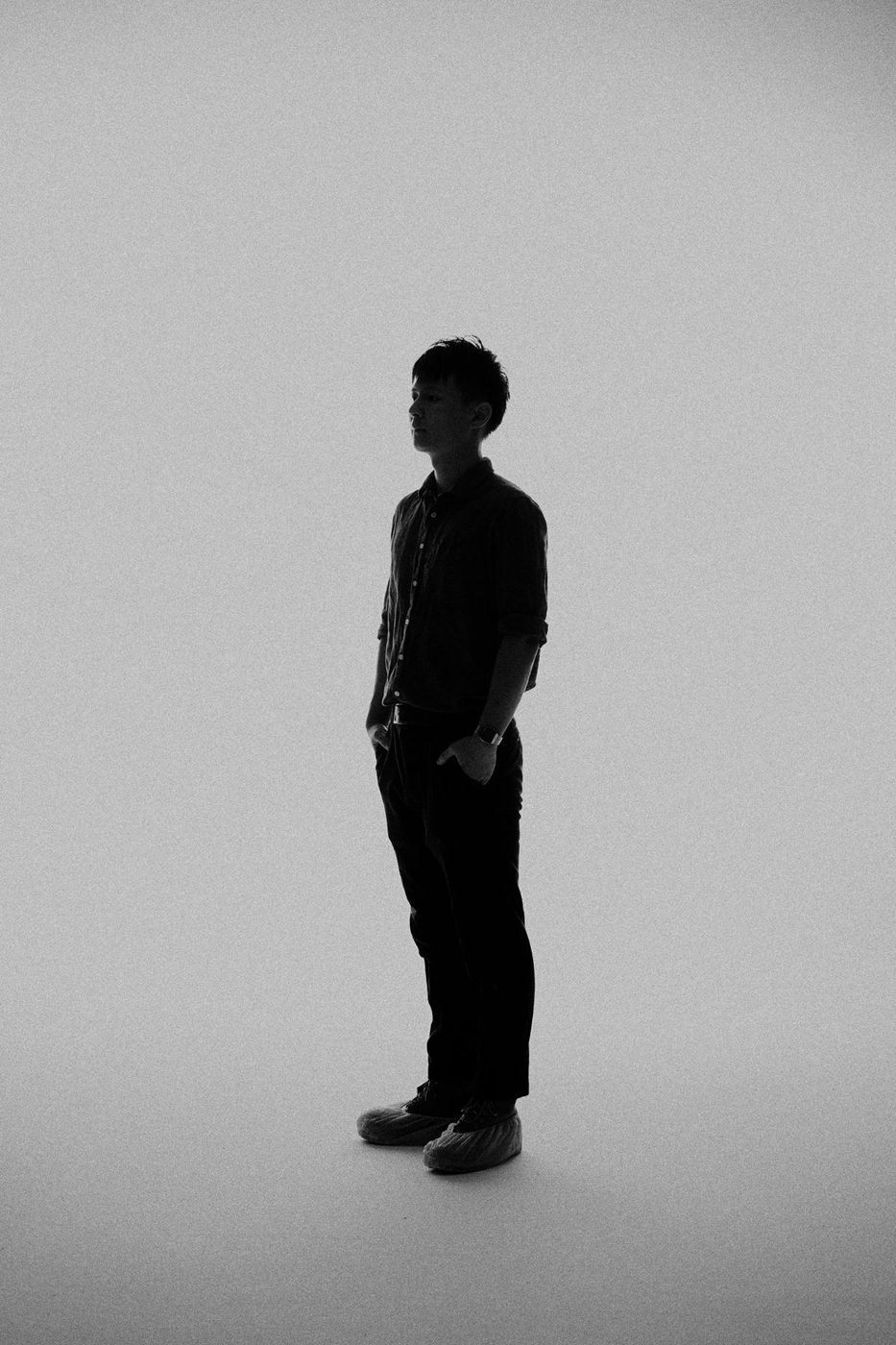 Masaya Hirose in silhouette with a red sun behind him