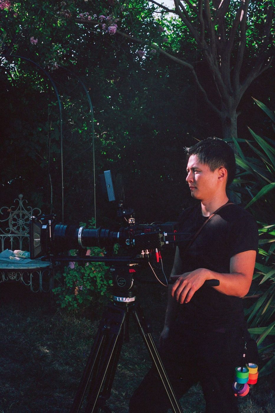 Masaya at a cinema camera in a garden